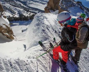 Skiers look into the entrance of Corbet’s Couloir.